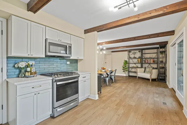 a kitchen with stainless steel appliances a stove a sink and a refrigerator