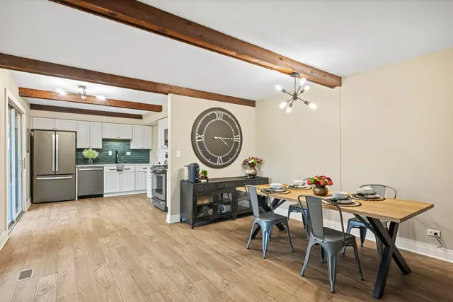 a kitchen with a table and chairs