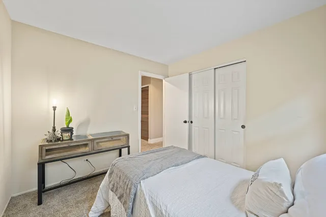 a bedroom with a bed and a lamp