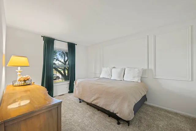 a bedroom with a bed and a dresser