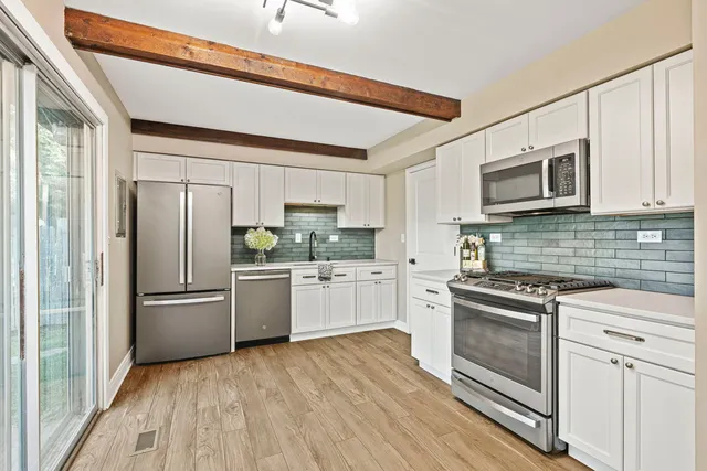 a kitchen with a refrigerator stove and sink