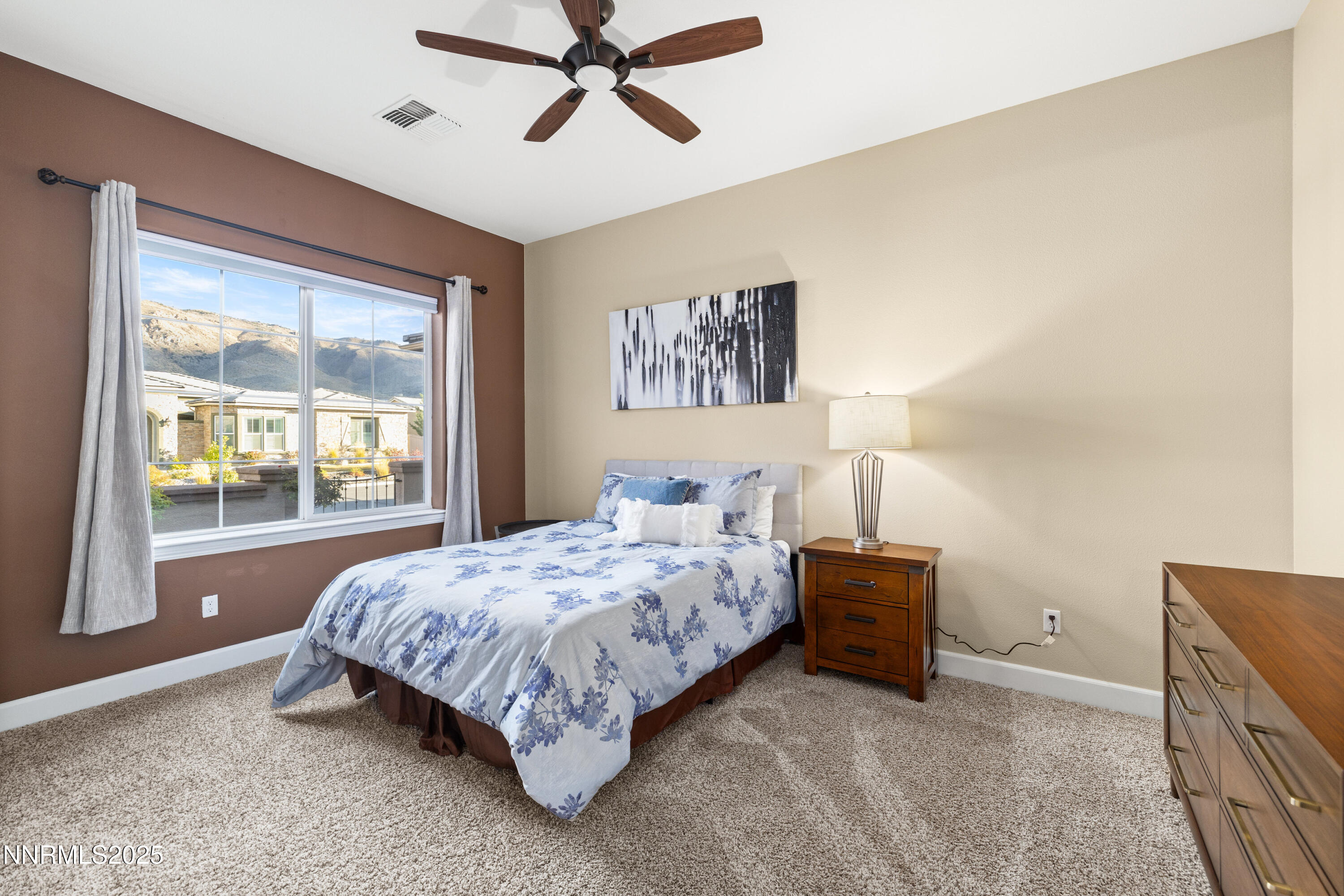 9845 Sea Breeze Lane Reno, NV 89521 - Photo 18 of 41 a bedroom with a bed and a large window