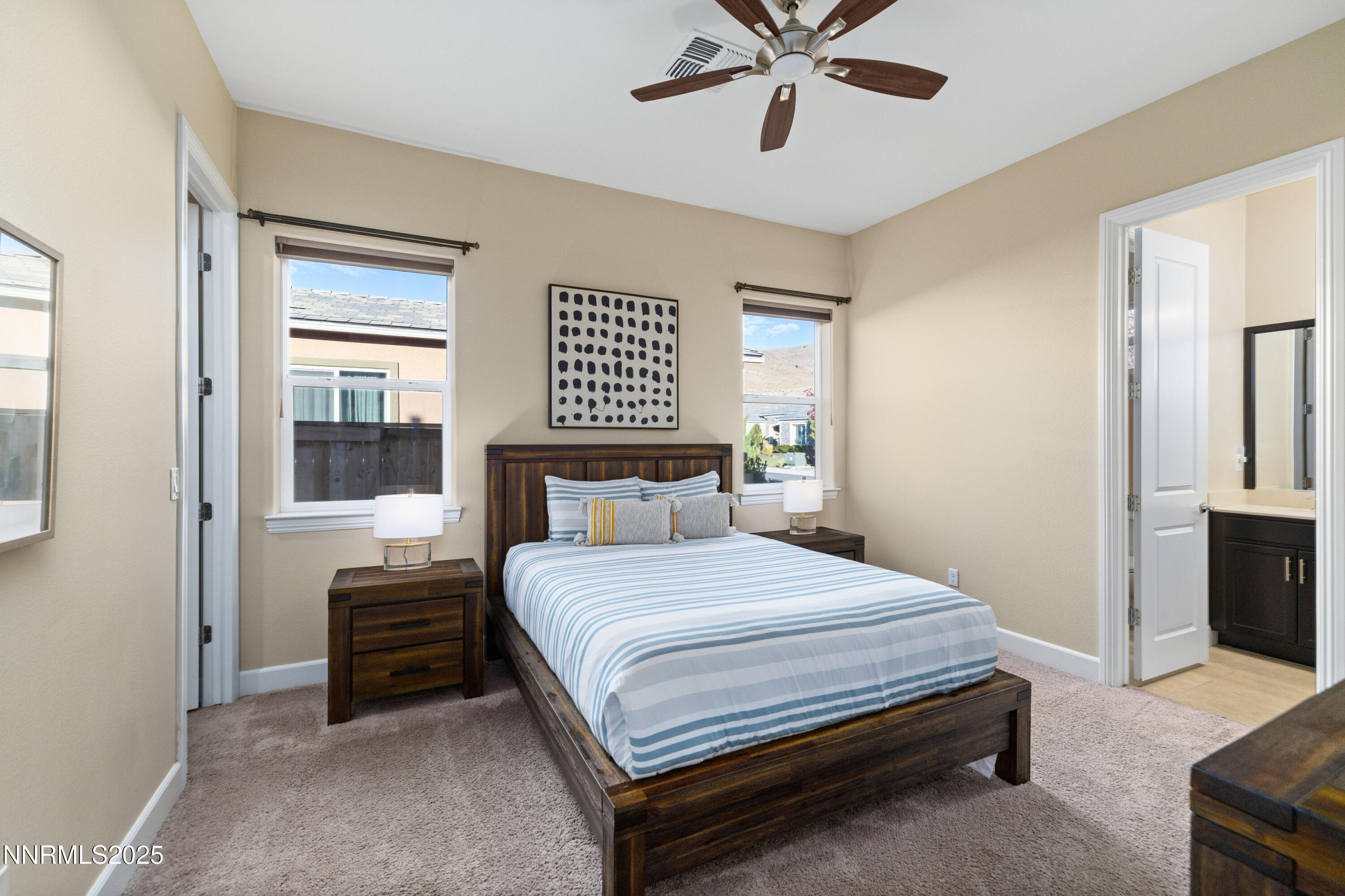 9845 Sea Breeze Lane Reno, NV 89521 - Photo 21 of 41 a bedroom with a bed and a chandelier
