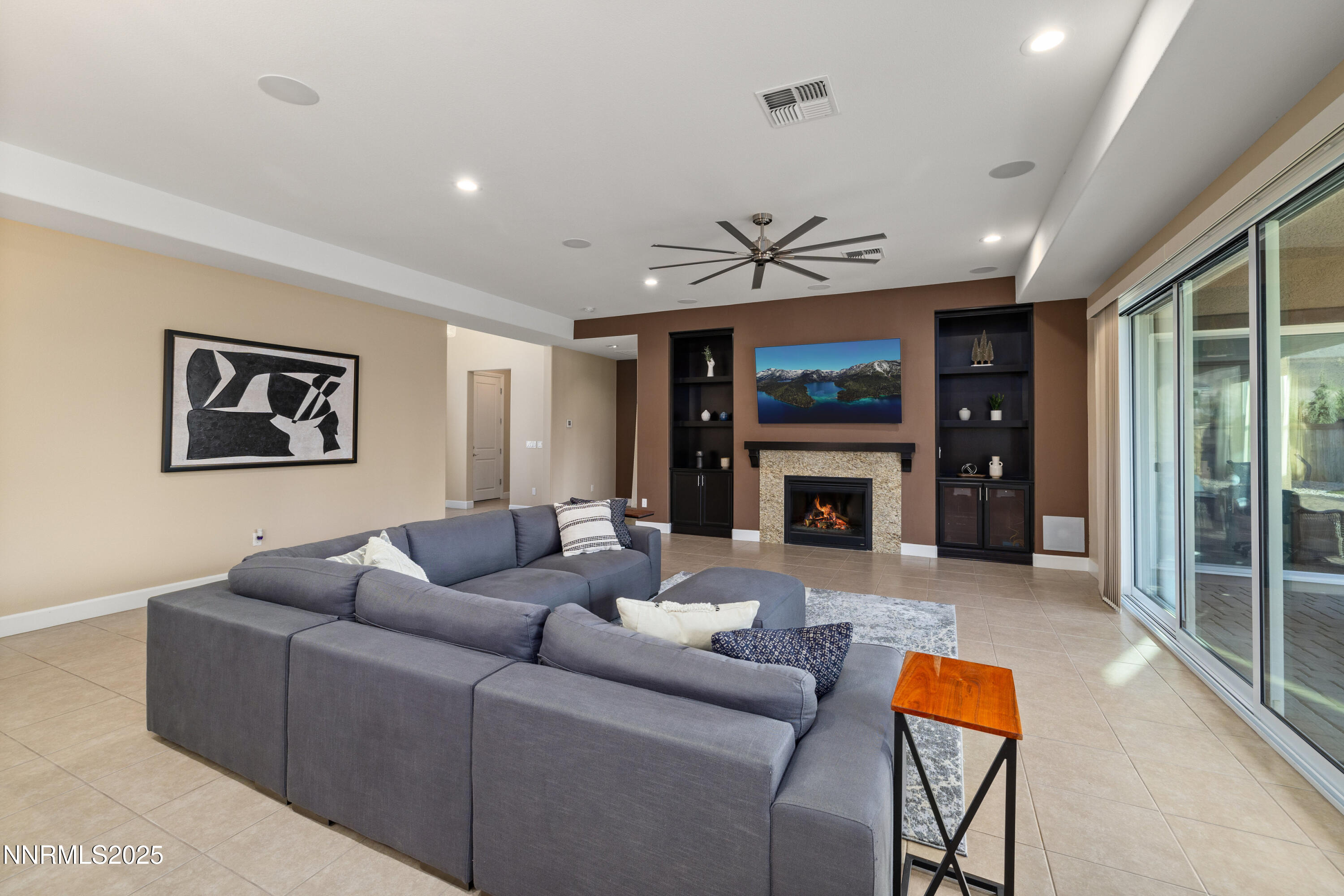 9845 Sea Breeze Lane Reno, NV 89521 - Photo 5 of 41 a living room with furniture a fireplace and a flat screen tv