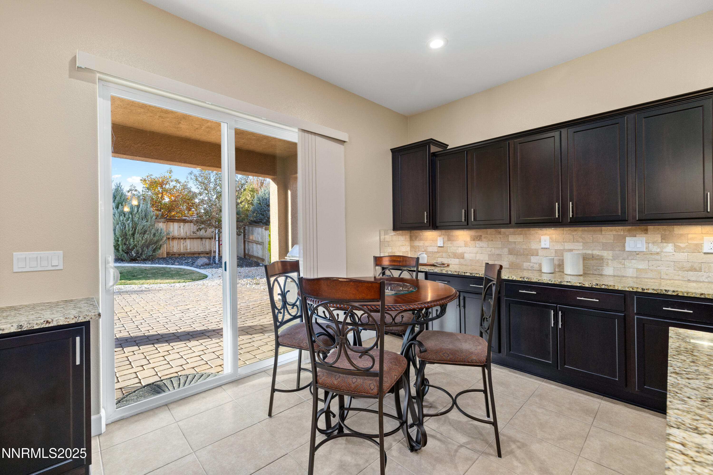 9845 Sea Breeze Lane Reno, NV 89521 - Photo 8 of 41 a kitchen with granite countertop wooden cabinets and dining table