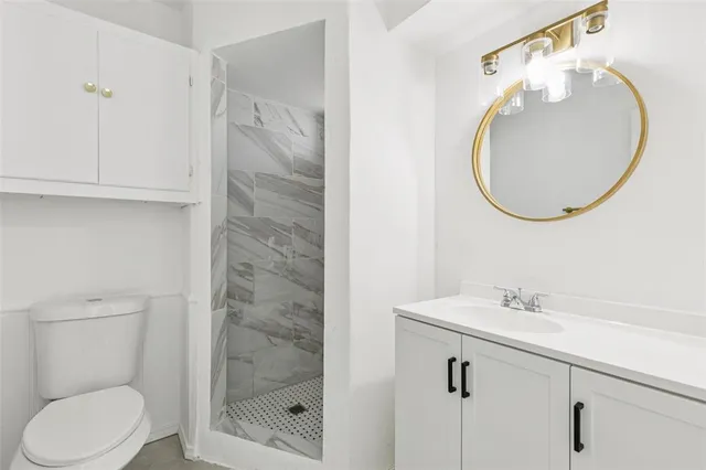 a bathroom with a toilet a sink and mirror