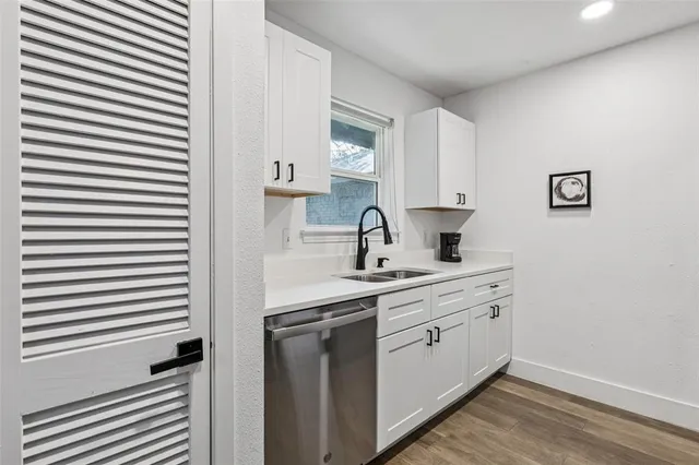 a kitchen with a sink cabinets and window