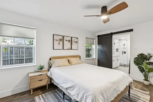 a spacious bedroom with a bed and a large window