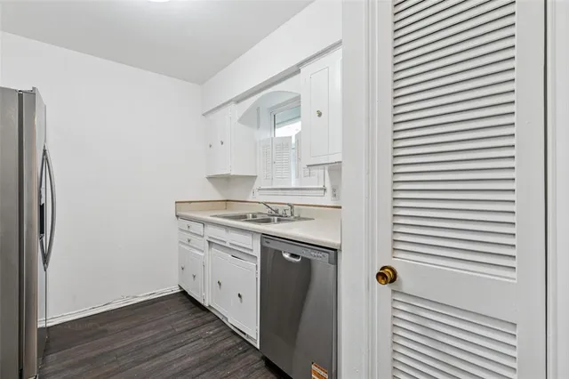 a kitchen with a stove cabinets and wooden floor