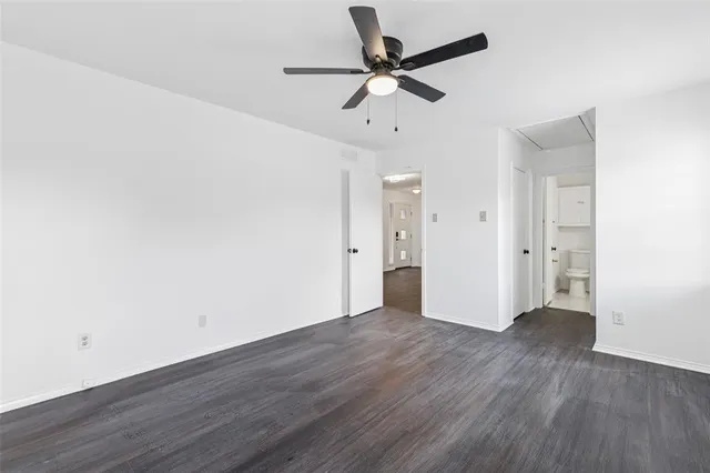 a view of a room with wooden floor and a ceiling fan