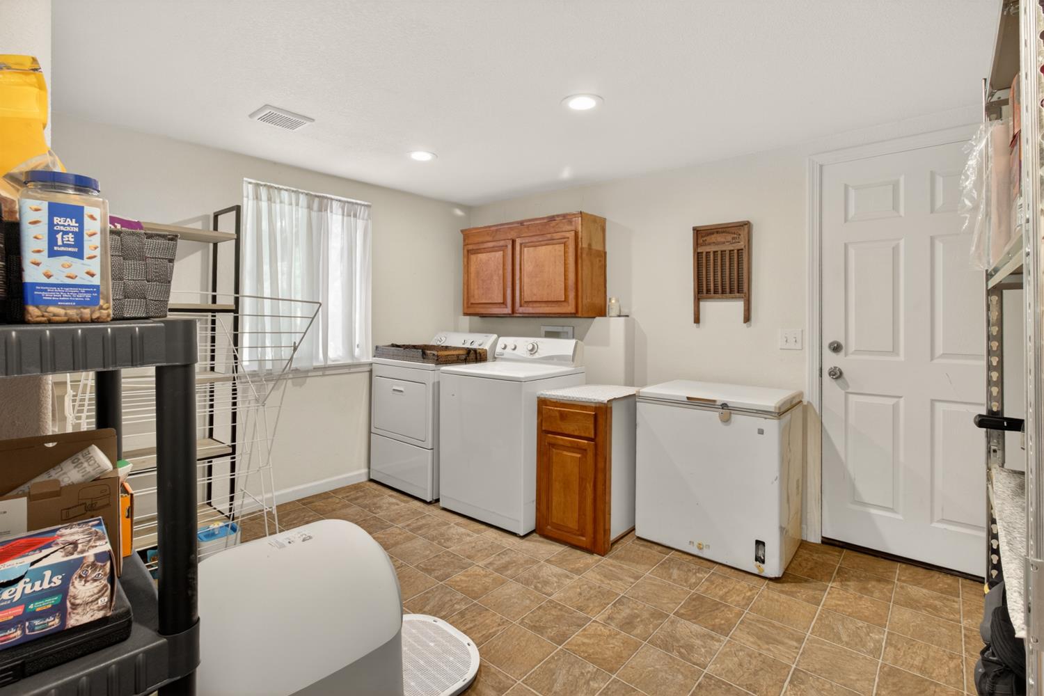 6332 Horseshoe Bar Road Loomis, CA 95650 - Photo 18 of 85 Functional utility space featuring a window, overhead cabinetry, and tile flooring