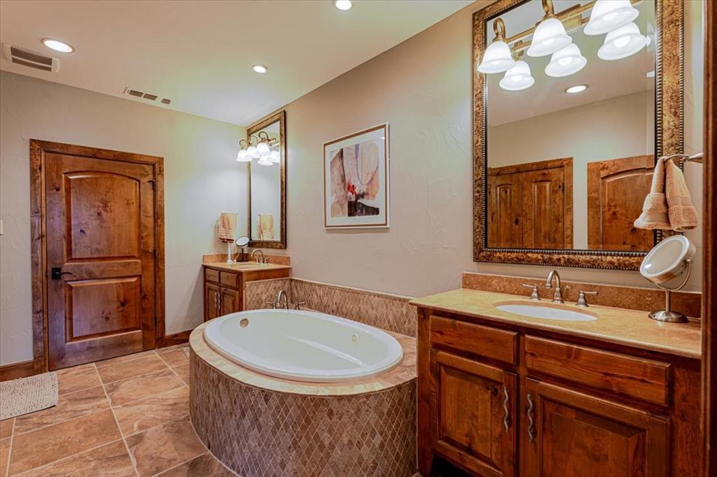 2033 Harbor Way, Unit 103 Graford, TX 76449 - Photo 11 of 22 a bathroom with a sink a toilet and mirror