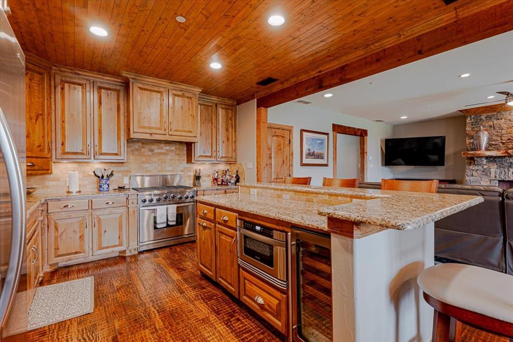 2033 Harbor Way, Unit 103 Graford, TX 76449 - Photo 4 of 22 a kitchen with stainless steel appliances granite countertop a stove sink and cabinets