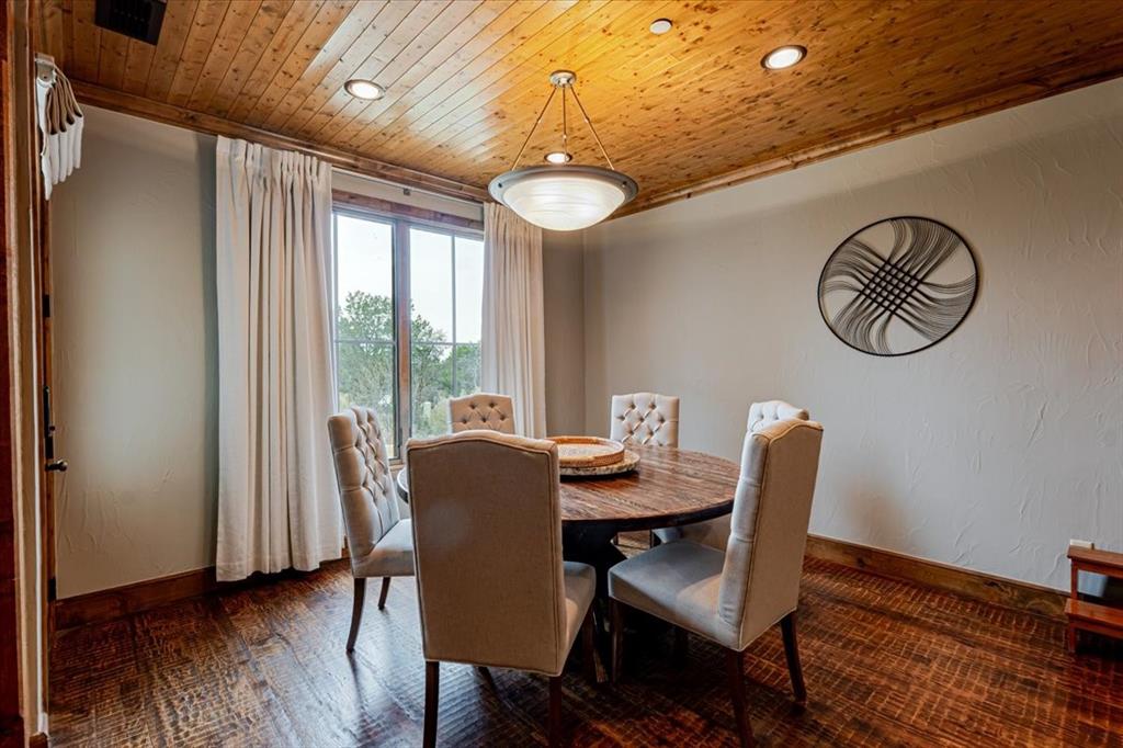 2033 Harbor Way, Unit 103 Graford, TX 76449 - Photo 8 of 22 a view of a dining room with furniture window and wooden floor