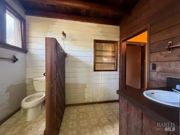 a bathroom with a toilet a sink and shower