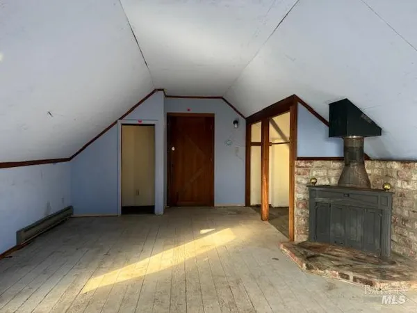 wooden floor in an empty room with a fireplace