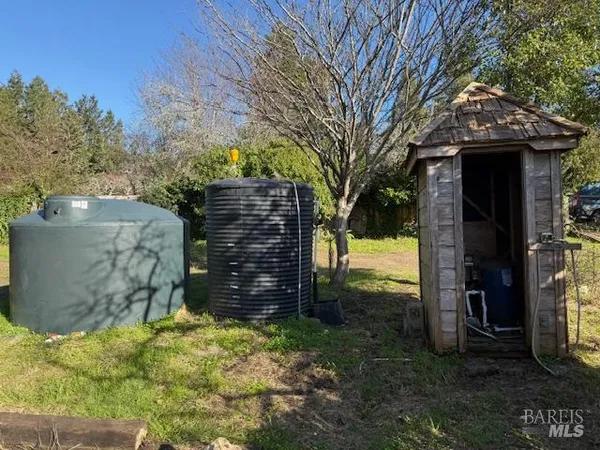 a view of a wooden door and a yard