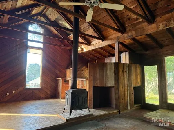 a view of a room with wooden floor and windows