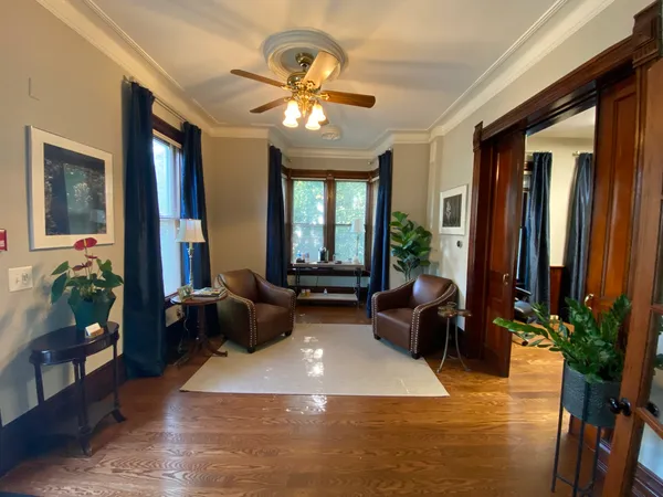 a living room with furniture and large windows