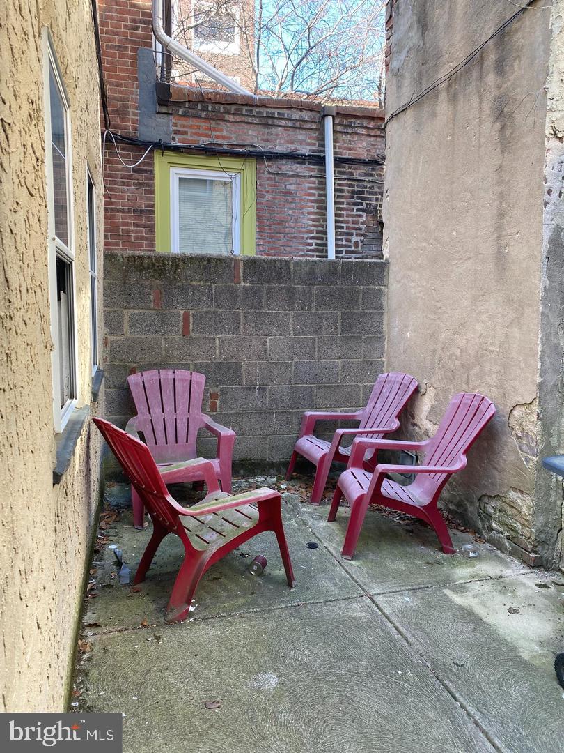 737 Spruce Street, Unit 3 Philadelphia, PA 19106 - Photo 15 of 15 a view of a backyard with table and chairs and wooden fence