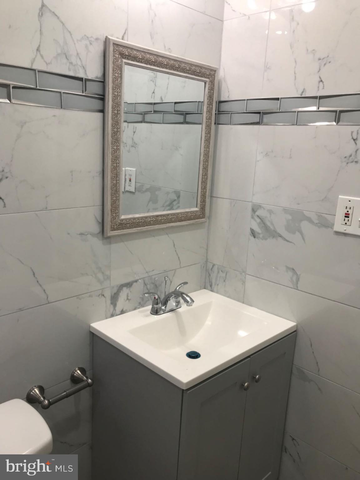 737 Spruce Street, Unit 3 Philadelphia, PA 19106 - Photo 6 of 15 a bathroom with a sink and mirror