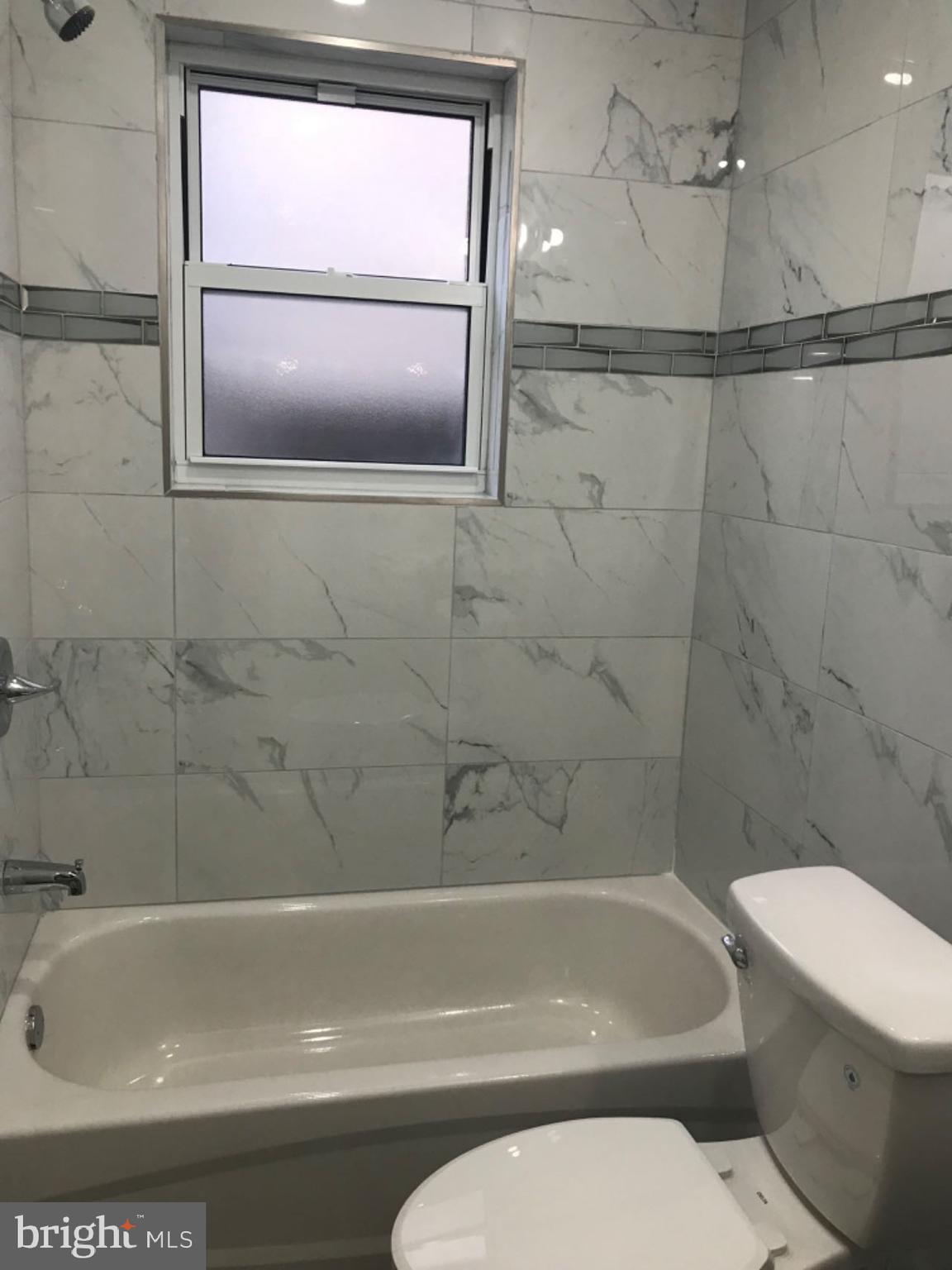 737 Spruce Street, Unit 3 Philadelphia, PA 19106 - Photo 7 of 15 a bathroom with a toilet and a bath tub