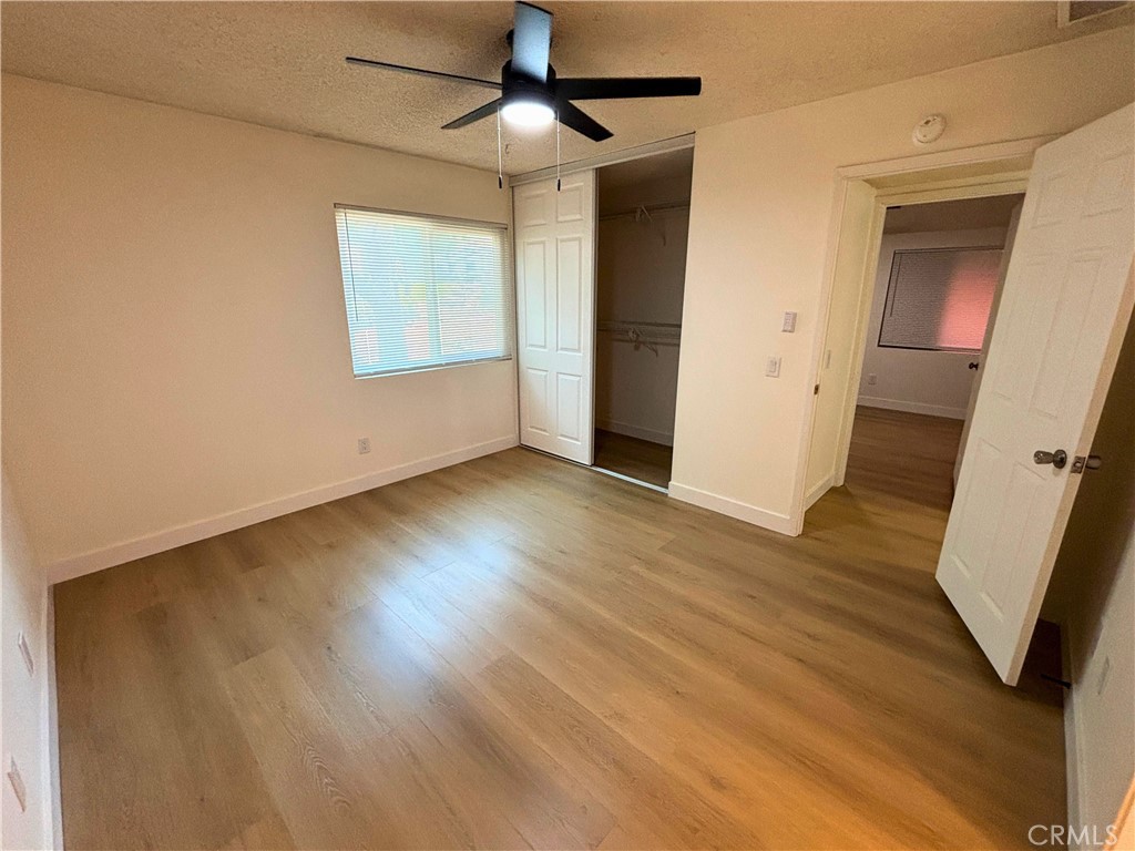 1356 Wheaton Way Riverside, CA 92507 - Photo 14 of 21 a view of an empty room with wooden floor and a window
