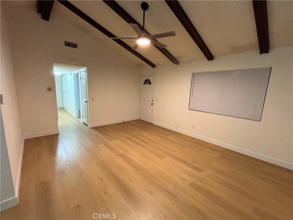 1356 Wheaton Way Riverside, CA 92507 - Photo 3 of 21 an empty room with wooden floor and windows