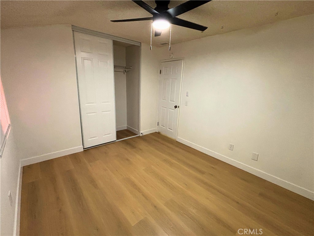 1356 Wheaton Way Riverside, CA 92507 - Photo 8 of 21 an empty room with a ceiling fan and carpet