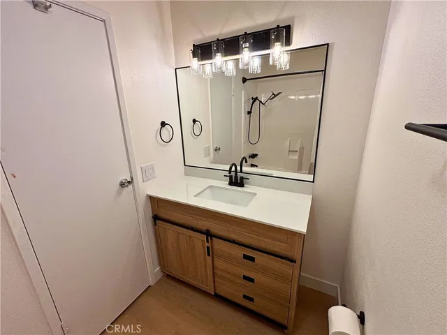 a bathroom with a shower sink and mirror