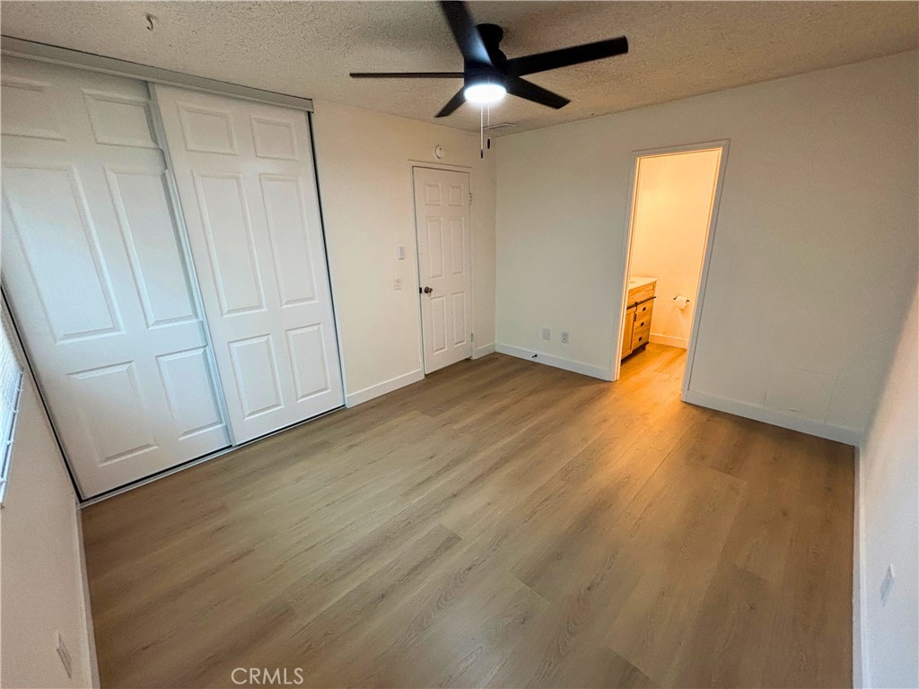 1356 Wheaton Way Riverside, CA 92507 - Photo 10 of 21 an empty room with wooden floor and windows