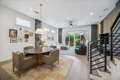 a living room with furniture a flat screen tv and a large window
