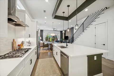 a kitchen with stainless steel appliances a sink a stove and a refrigerator