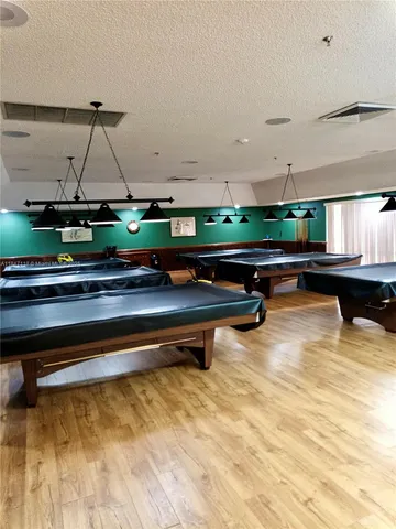 a room with lots of table tennis chairs and wooden floor