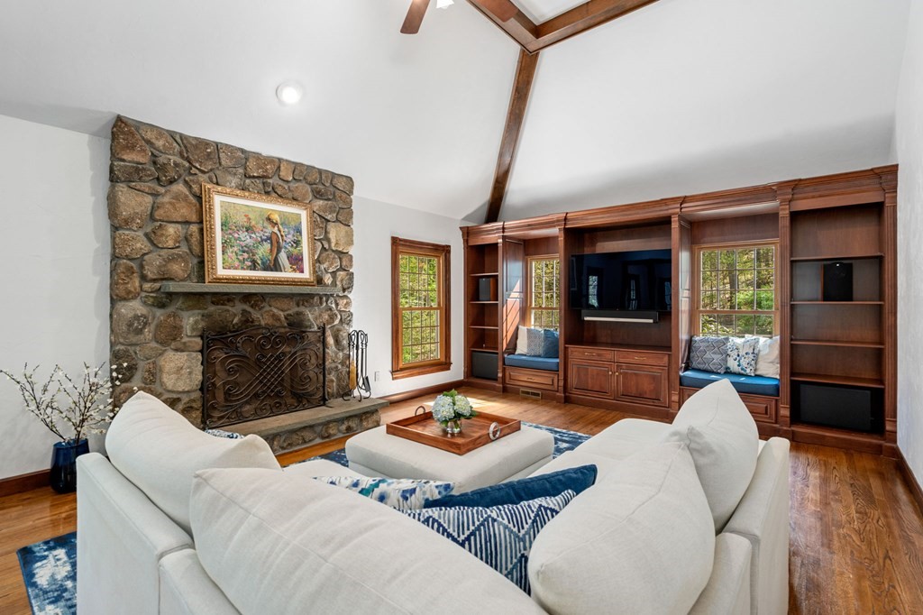 92 Lincoln Road Wayland, MA 01778 - Photo 12 of 40 a living room with furniture flat screen tv and a fireplace