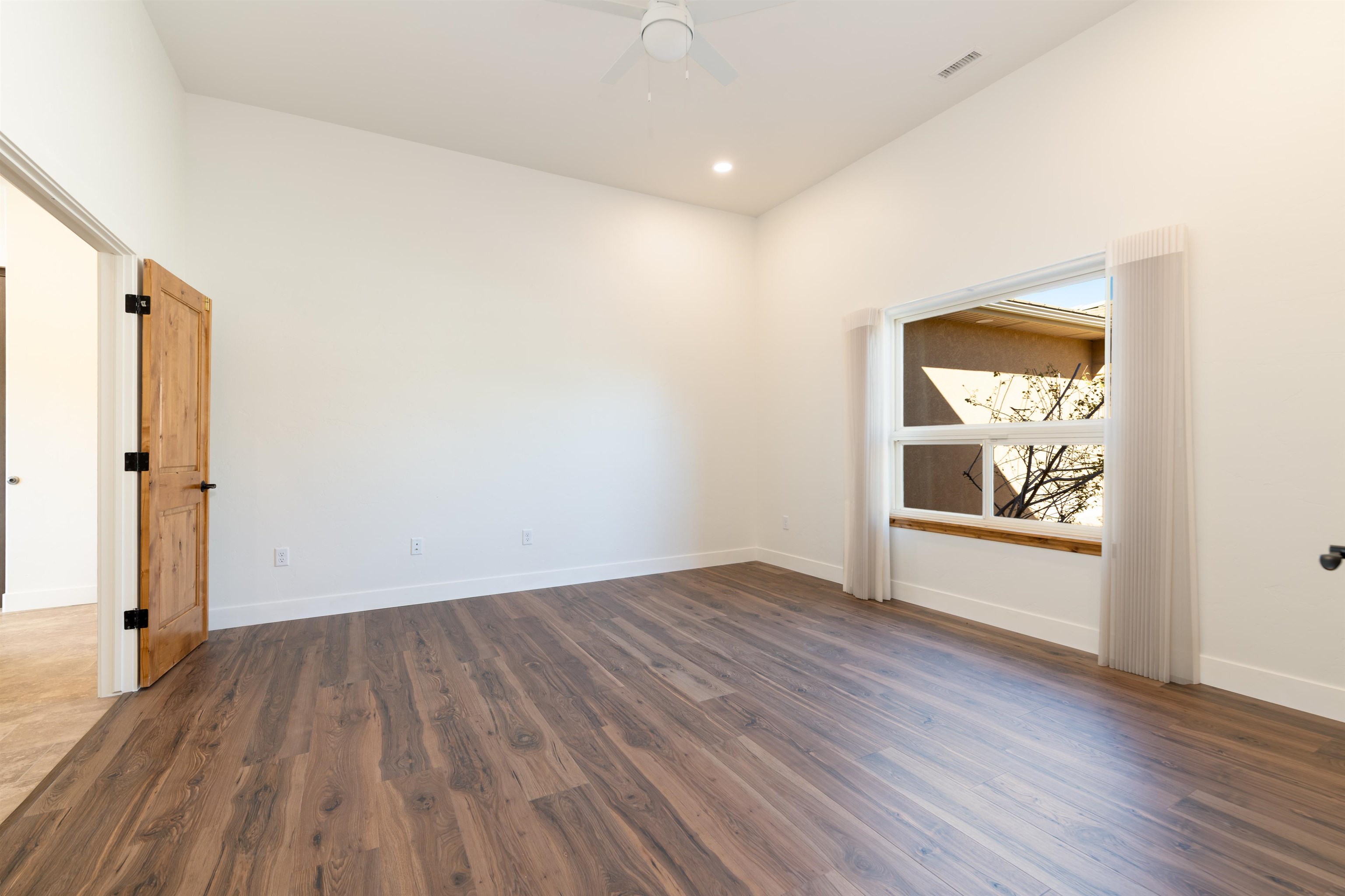 372 High Desert Road Grand Junction, CO 81507 - Photo 17 of 40 an empty room with wooden floor and windows