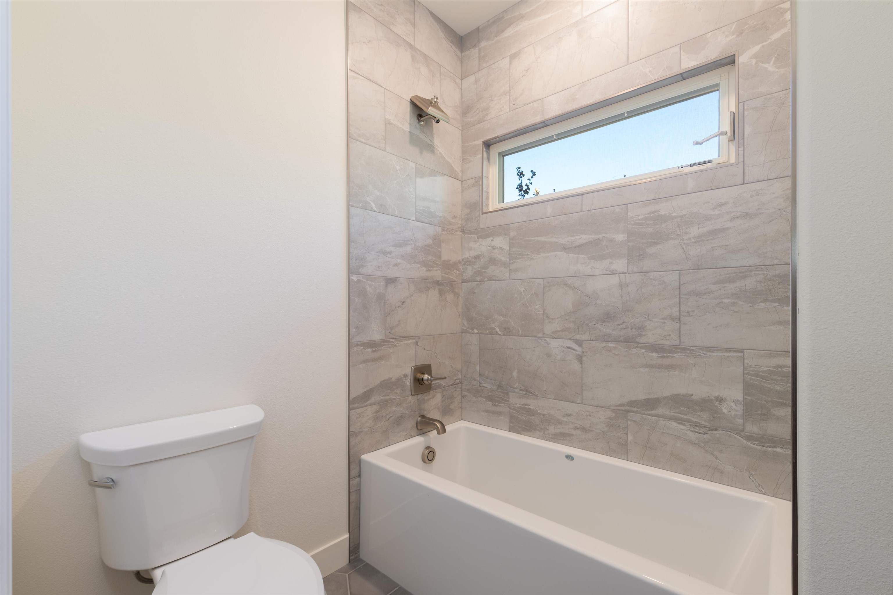 372 High Desert Road Grand Junction, CO 81507 - Photo 21 of 40 a white toilet sitting next to a bathtub