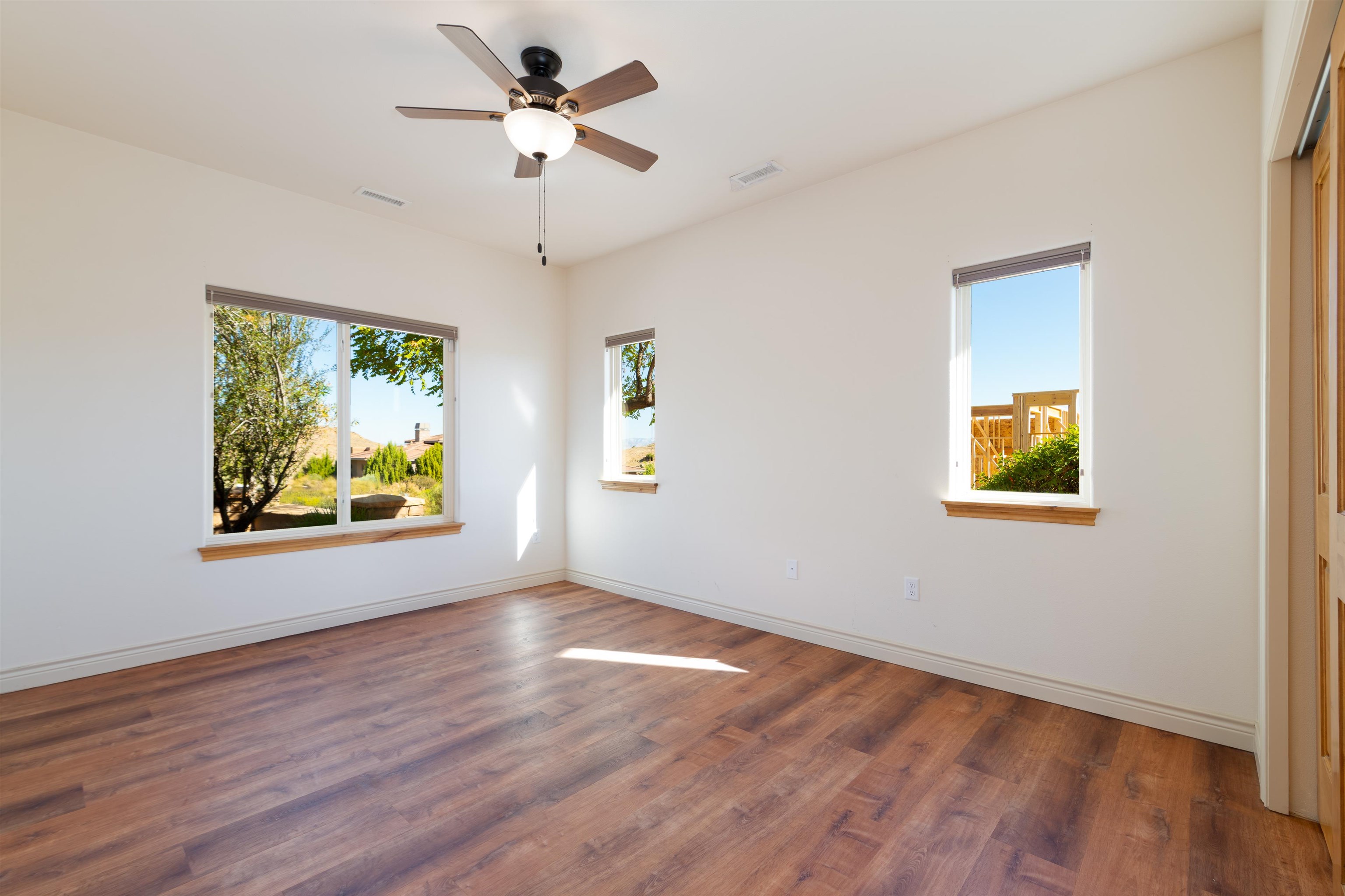 372 High Desert Road Grand Junction, CO 81507 - Photo 22 of 40 a view of an empty room with window and wooden floor