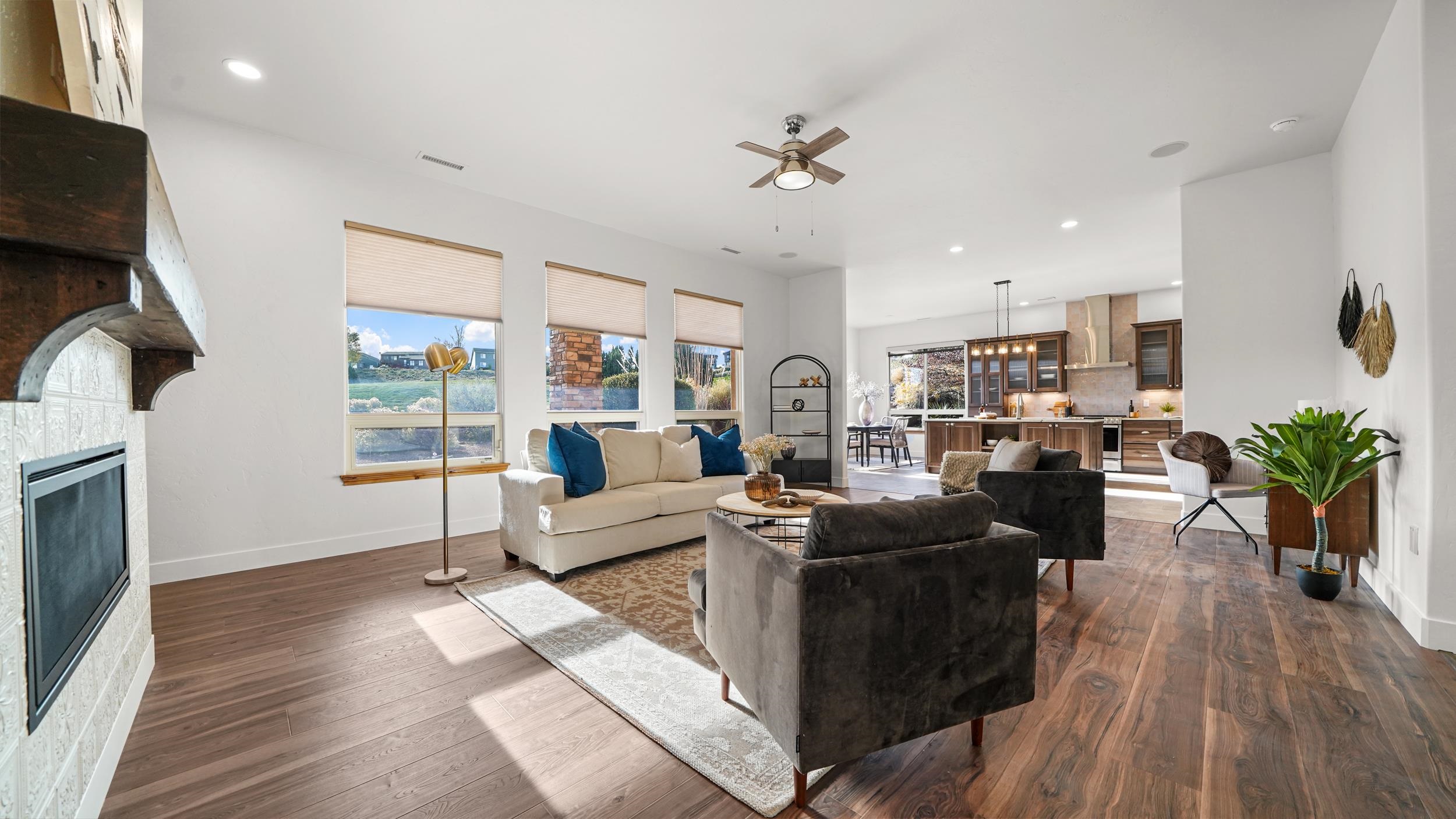 372 High Desert Road Grand Junction, CO 81507 - Photo 3 of 40 a living room with furniture or wooden floor and a fireplace