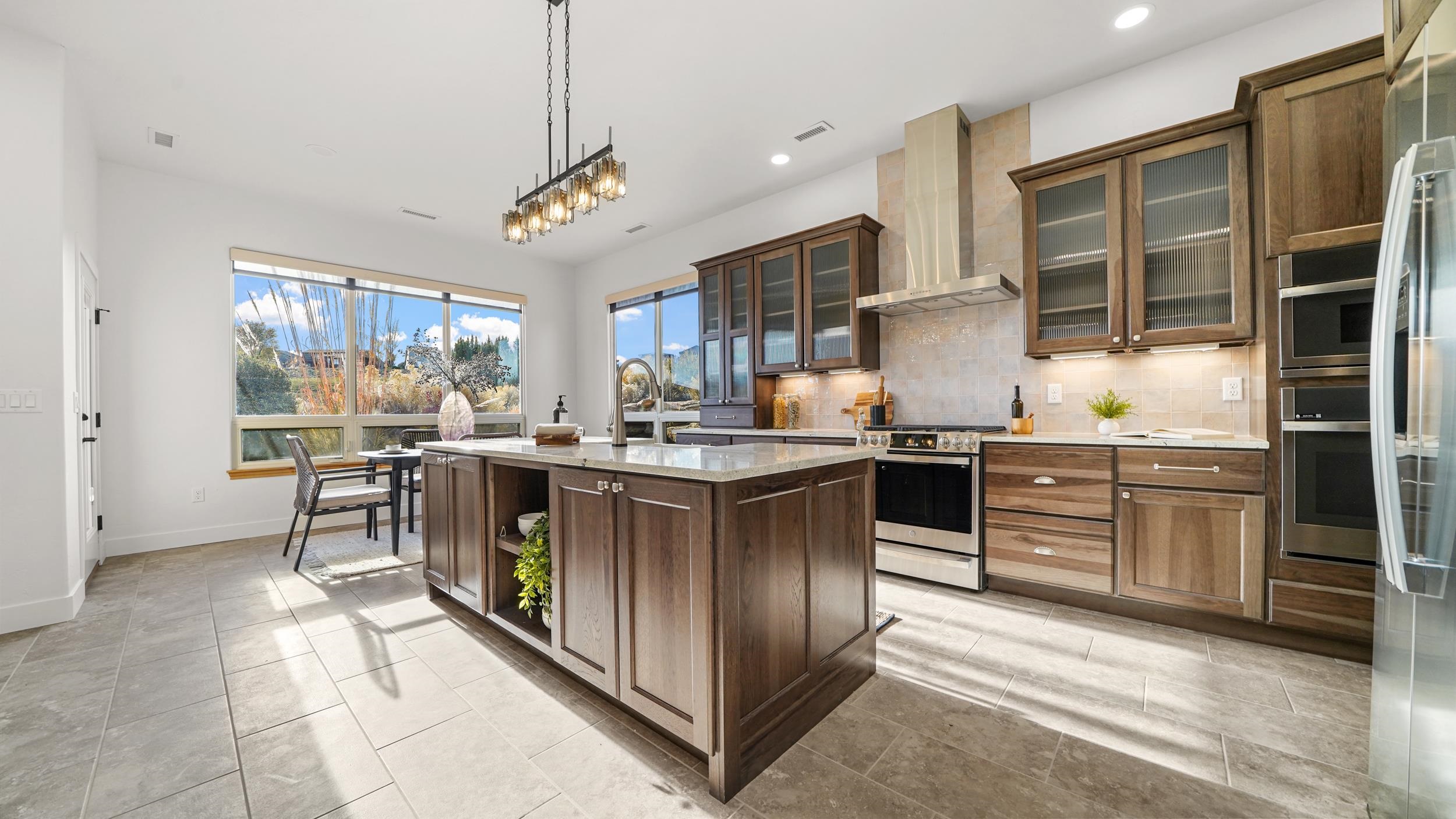 372 High Desert Road Grand Junction, CO 81507 - Photo 4 of 40 a kitchen with stainless steel appliances granite countertop a stove oven and a refrigerator