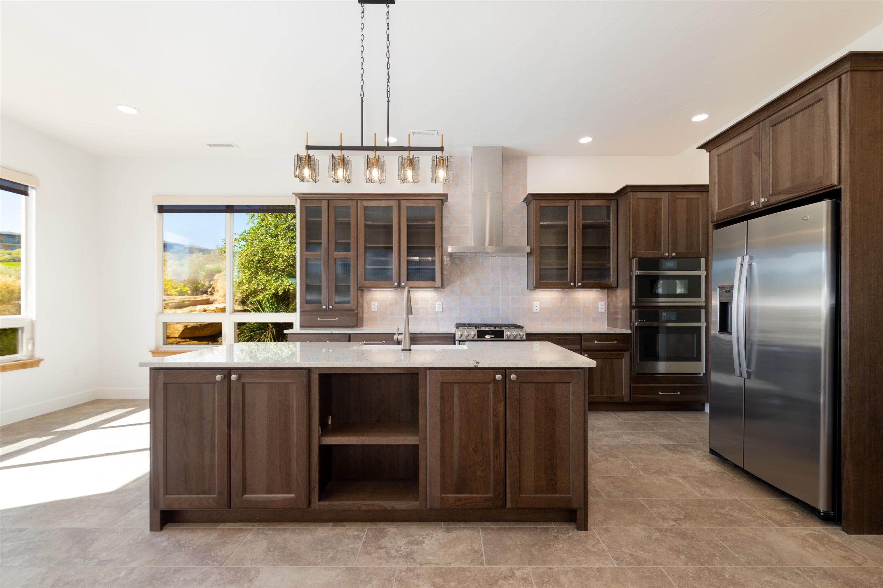 372 High Desert Road Grand Junction, CO 81507 - Photo 6 of 40 a kitchen with stainless steel appliances granite countertop a stove and a refrigerator