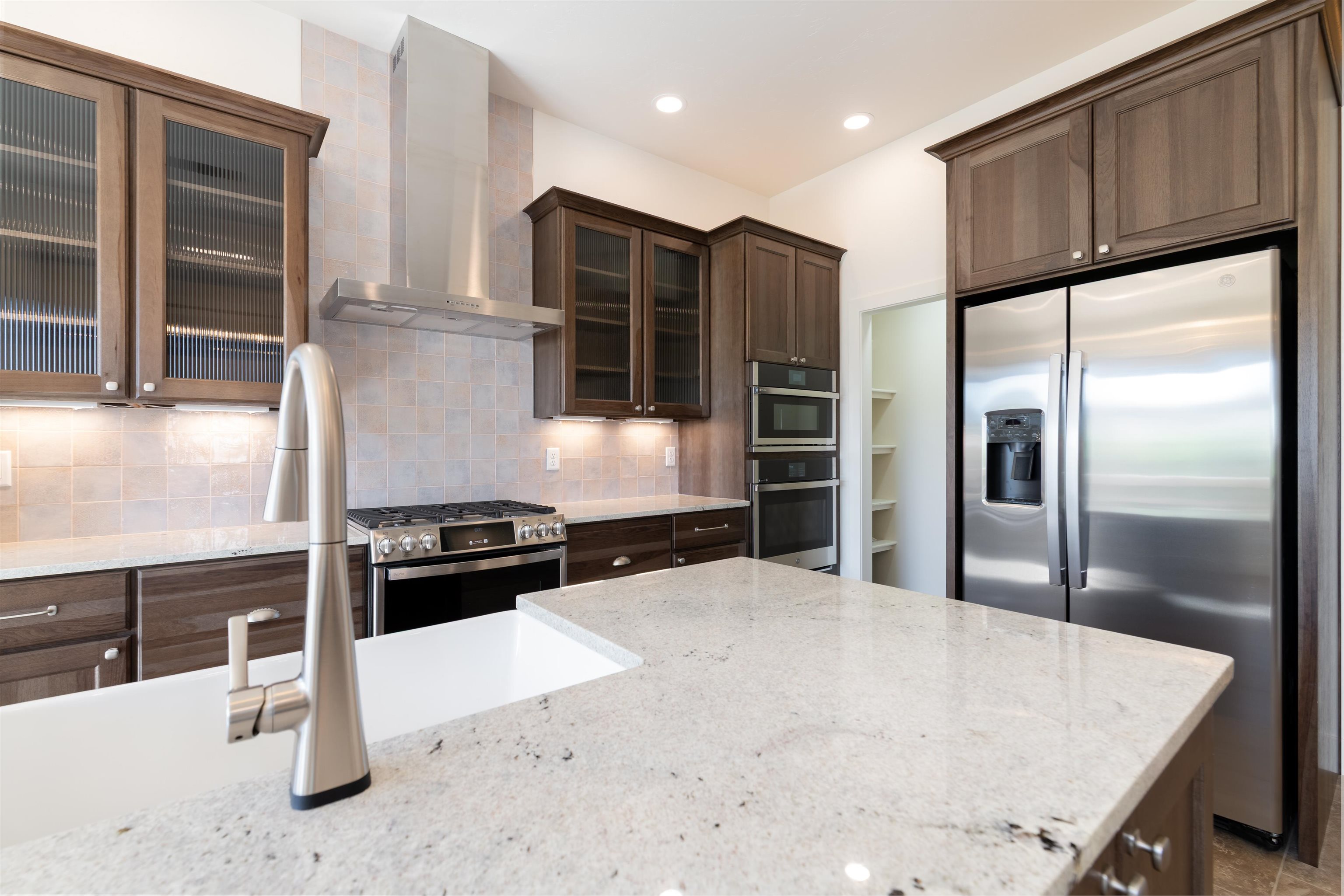 372 High Desert Road Grand Junction, CO 81507 - Photo 8 of 40 a kitchen with kitchen island a counter top space cabinets and stainless steel appliances