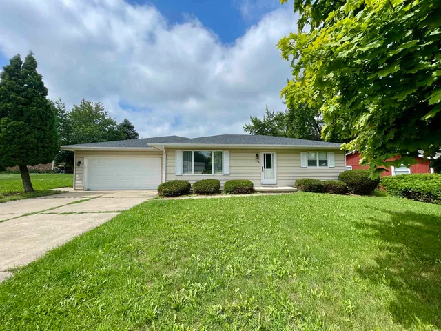 a view of a house with a yard and plants