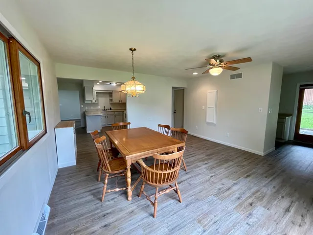 a view of a dining room with furniture and wooden floor