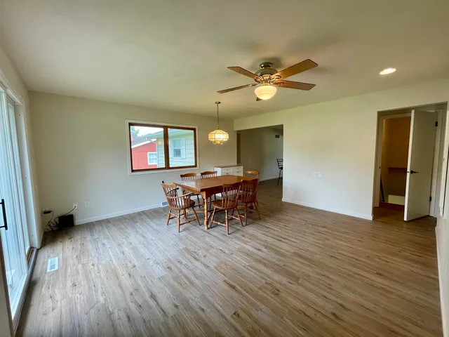 a dining room with furniture and wooden floor