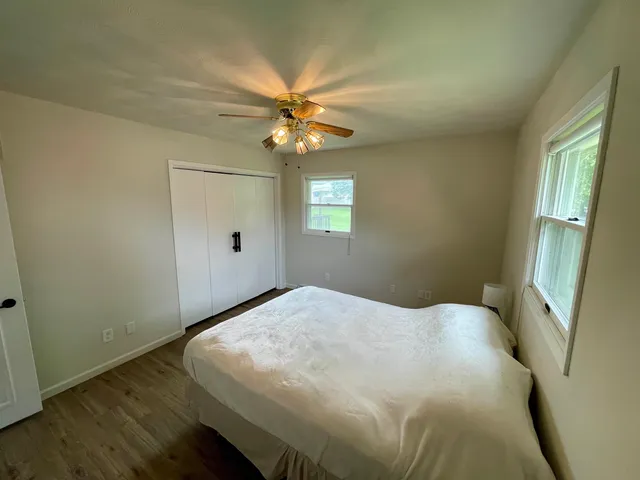 a bedroom with a bed and a window