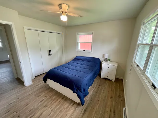 a spacious bedroom with a bed and a window