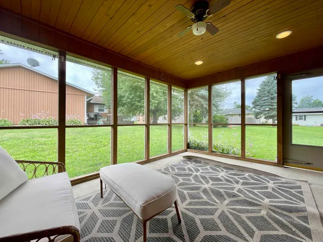 a bed sitting in a bedroom next to a large window