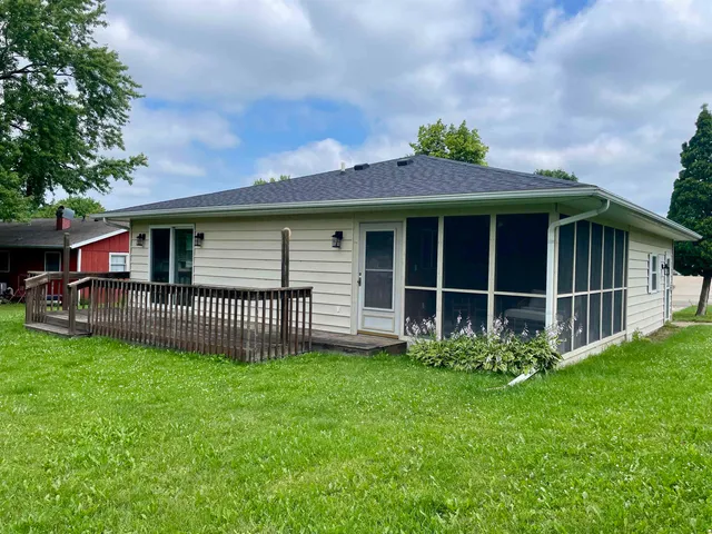 a view of a house with a yard and a porch
