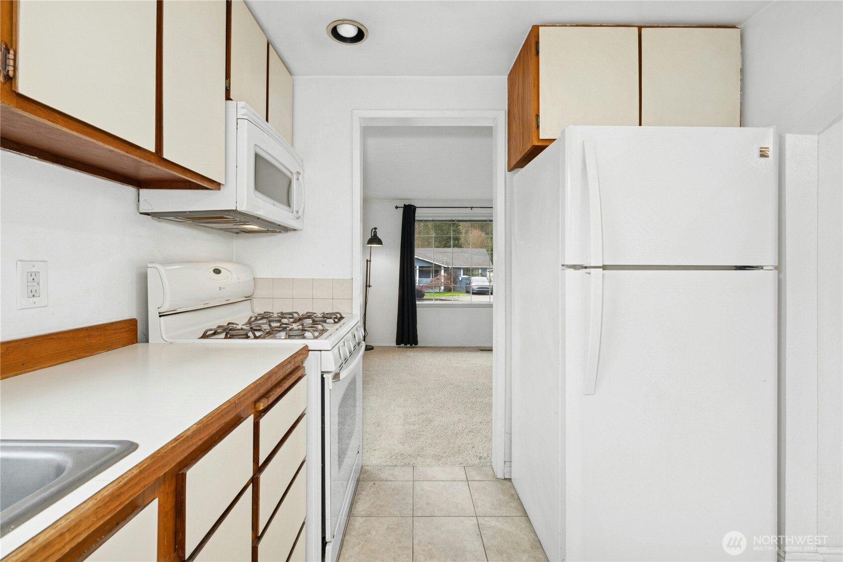 3125 Southeast 6th Street Renton, WA 98058 - Photo 13 of 27 a kitchen with a refrigerator and a stove